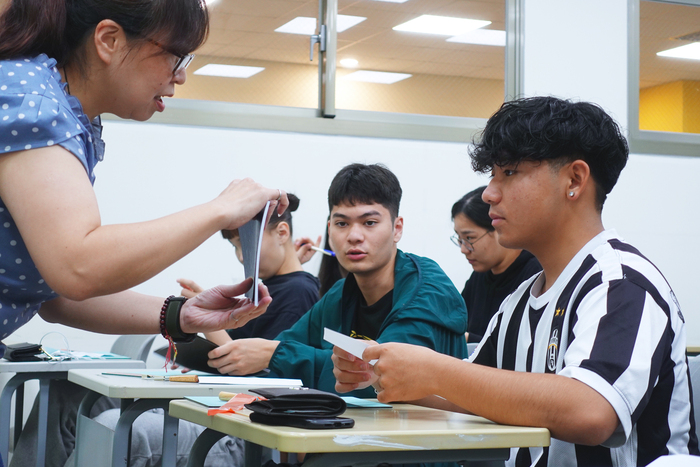 Students attempt how to bind book